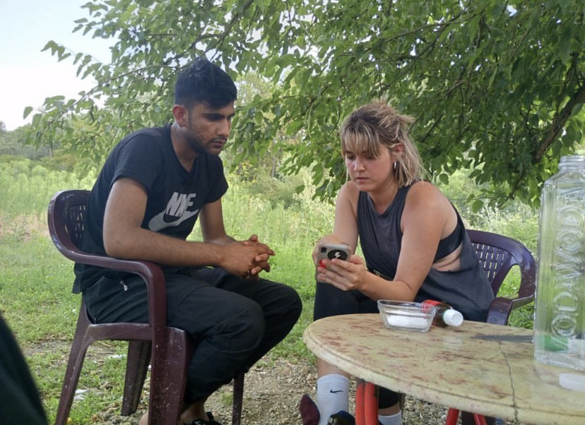 Marta interviewing a man in the Balkan route.