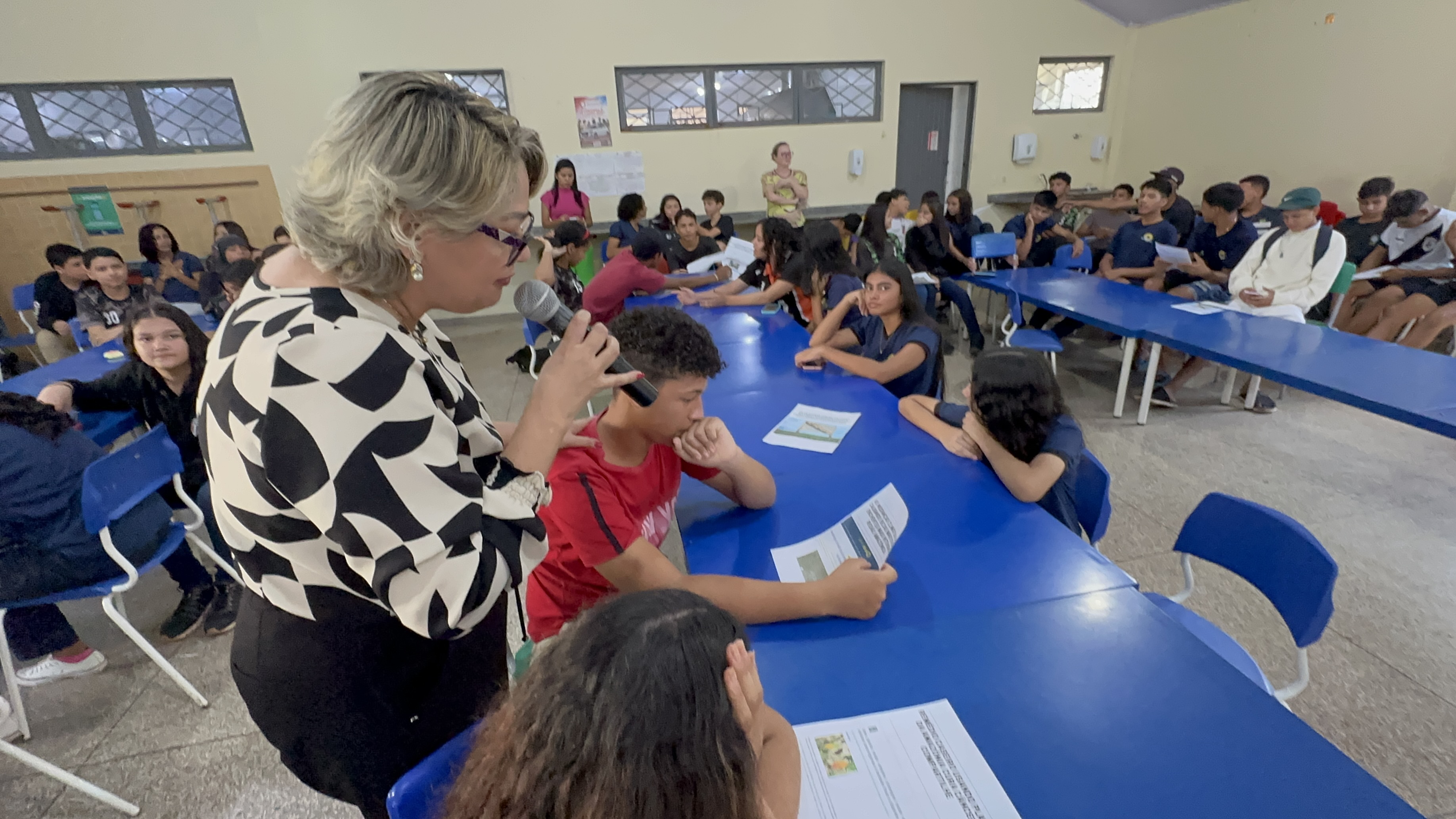 Jose speaking in a microphone as she leads a workshop for  students.