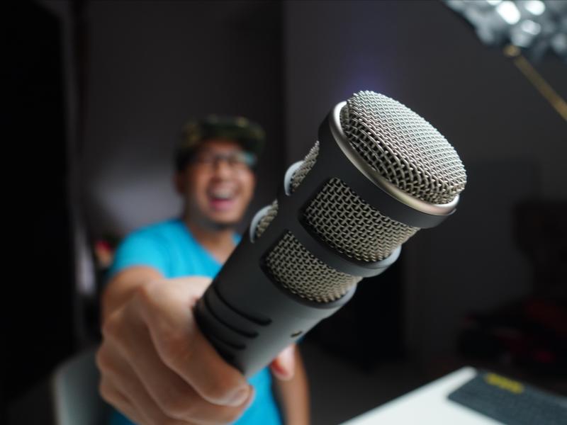 Man holding a microphone to the camera