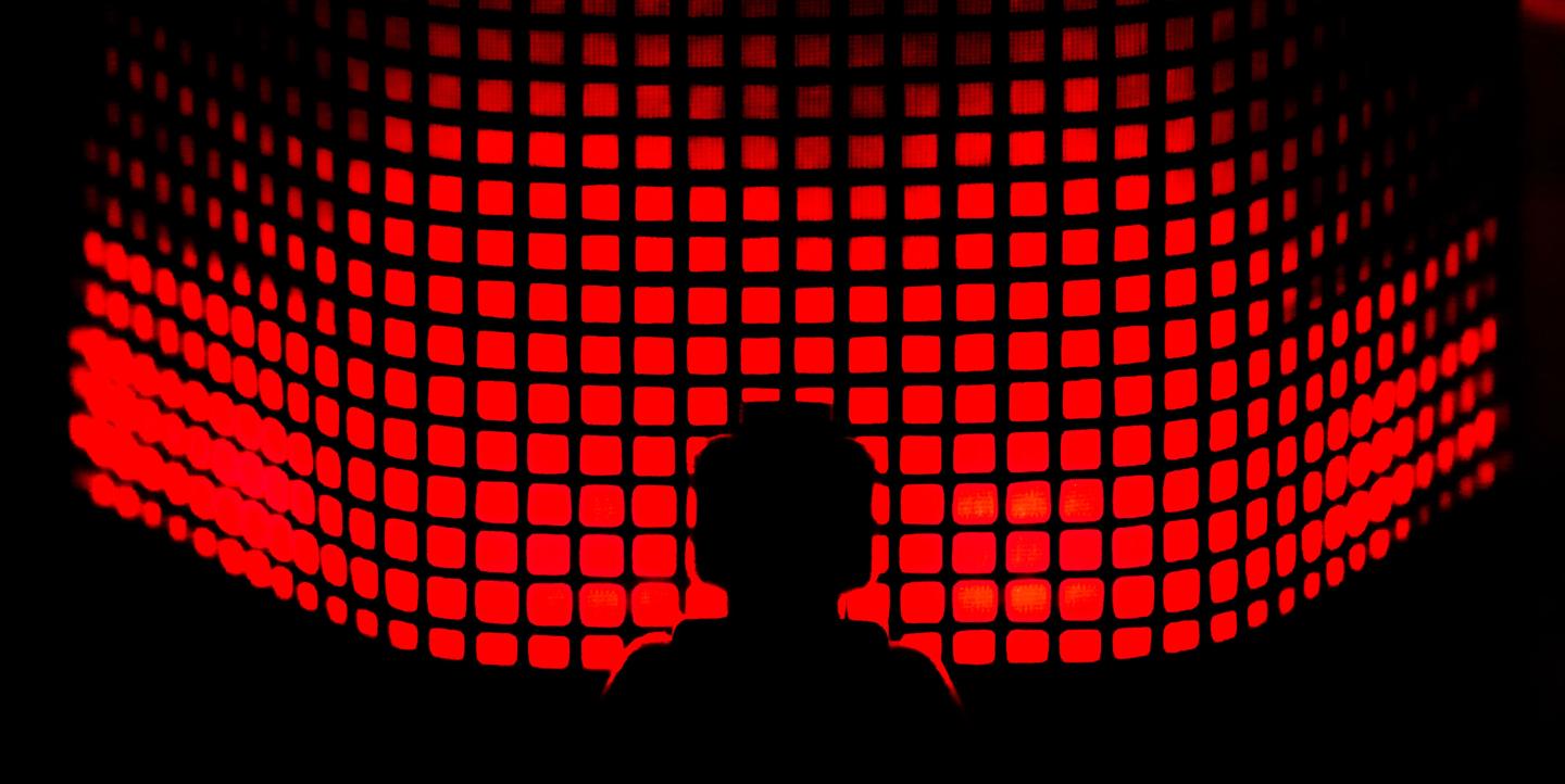 Robot in front of a red background