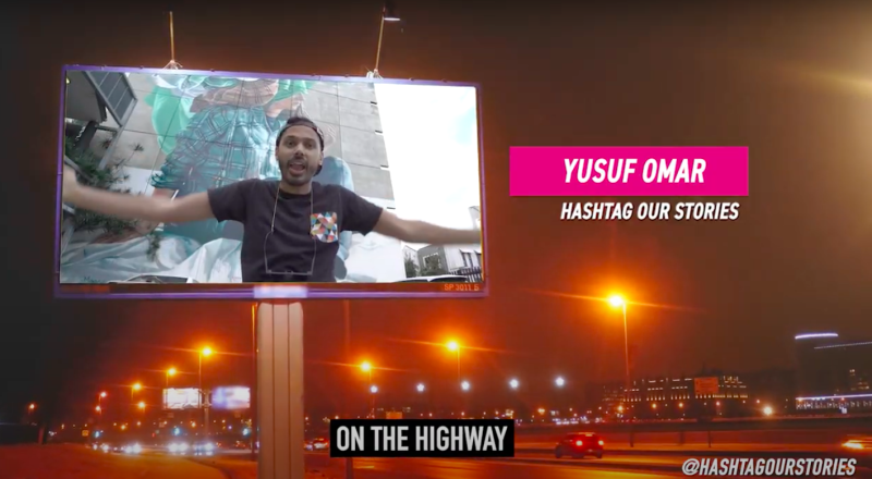 A man talking on a billboard.